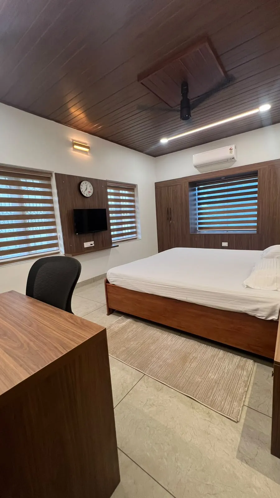 First bedroom with wall TV and desk